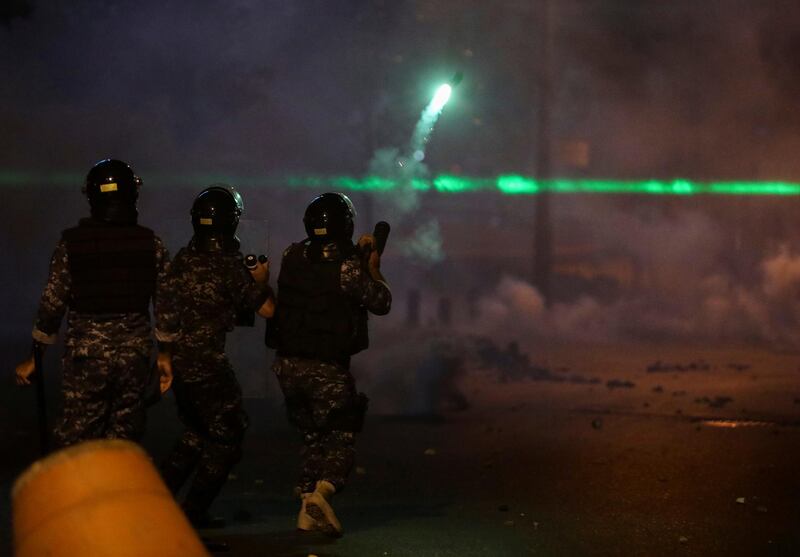 A member of the Lebanese riot police fires tear gas towards demonstrators during a protest against the fall in pound currency and mounting economic hardship, in Beirut. Reuters