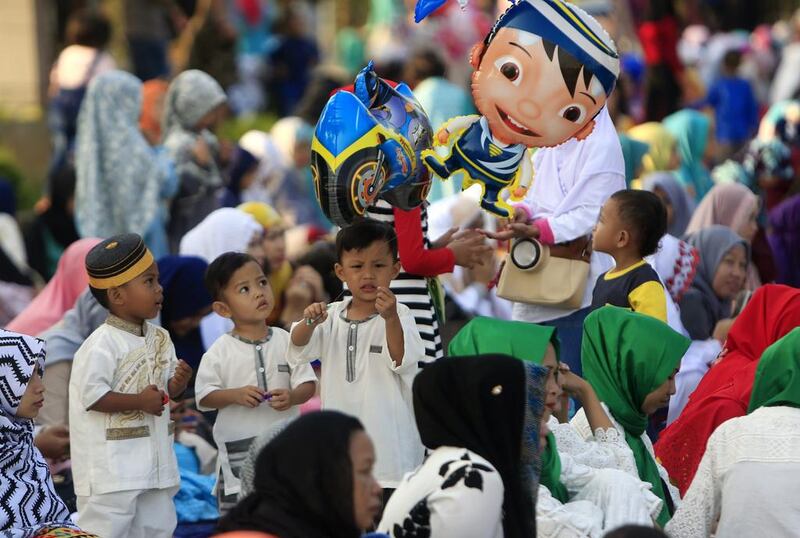 Indonesian children play with balloons at Sunda Kelapa port in Jakarta. Adi Weda / EPA