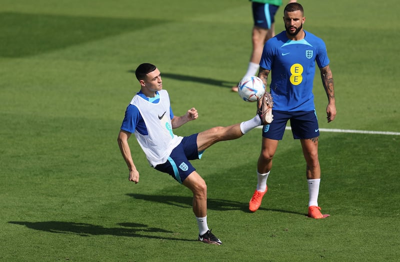 England's Phil Foden controls the ball next to Kyle Walker. Reuters