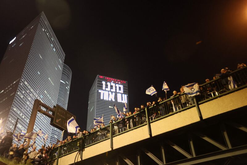 Protesters lineup on a walkway in Tel Aviv. AFP