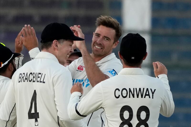 New Zealand's Tim Southee, centre, celebrates with teammates after taking the wicket of Pakistan's Abdullah Shafique on the fourth day of the second Test in Karachi, Pakistan, on Thursday, January 5, 2023. AP 