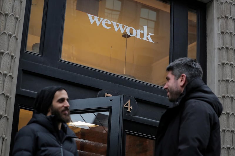 FILE PHOTO: People stand outside a WeWork co-working space in New York City, New York U.S., January 8, 2019. REUTERS/Brendan McDermid/File Photo