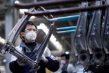 An employee works on a car seat assembly line at a factory in Shanghai. China’s economy continued to recover in July on the back of higher industrial production. Reuters