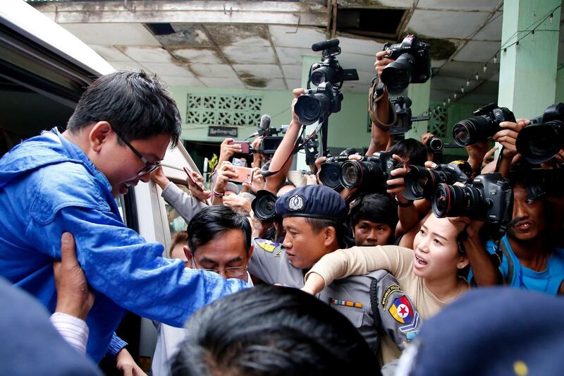 Reuters reporter Wa Lone's wife Pann Ei (2nd-R) try to catch his hand as he arrives at court in Yangon, Myanmar, December 27, 2017. REUTERS/Stringer   NO RESALES. NO ARCHIVE.