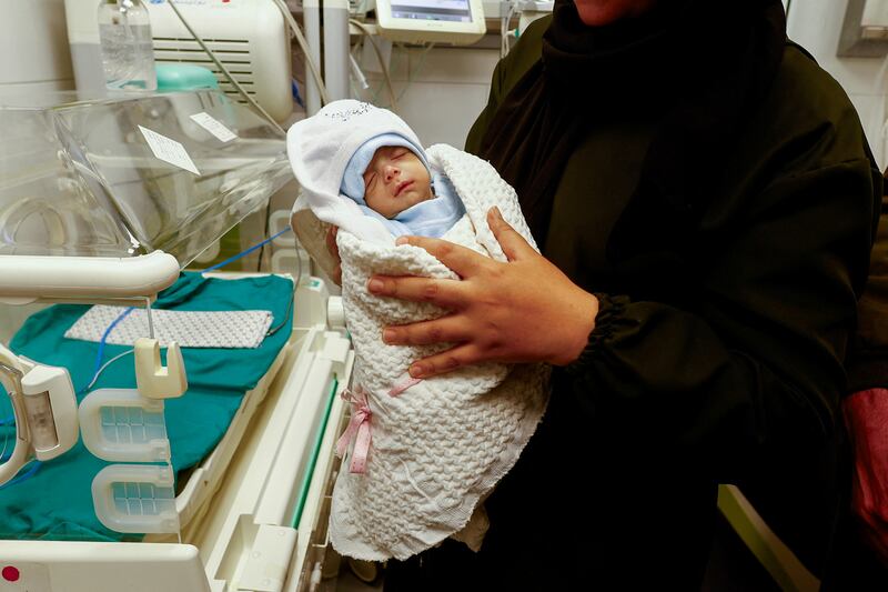 A Palestinian mother holds her newborn in a maternity hospital in Rafah, after he was evacuated from Al Shifa Hospital in Gaza city. Reuters