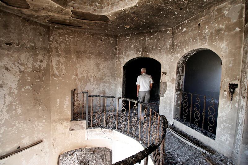 A man walks inside the headquarters of MP Faleh Al Khazali, Secretary General of the Martyrs movement, which were set on fire by protesters in Basra. Reuters