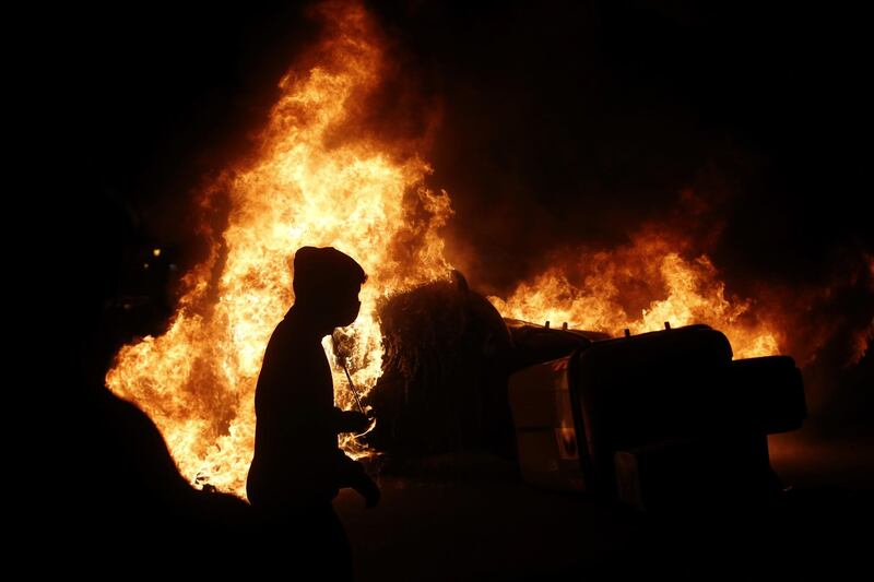 Flames erupt as the protests barrel on into the night. EPA