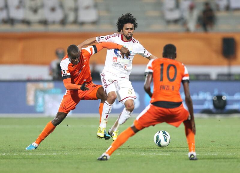Ajman (orange) fight for the ball Al Jazira (white), during the Pro League Etisalat Cup final at Al Wasl's Zabeel Stadium on May 14, 2013. ( Al Ittihad )
 