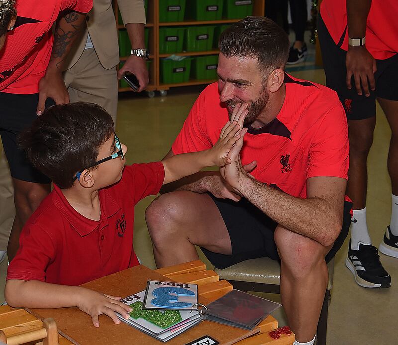 Adrian with a kid in Dubai on Wednesday. Getty