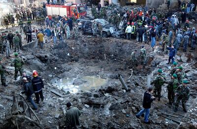 FILE - In this Feb. 14, 2005 file photo, rescue workers and soldiers stand around a massive crater after a bomb attack that tore through the motorcade of former Prime Minister Rafik Hariri in Beirut, Lebanon. A U.N.-backed tribunal investigating the 2005 assassination of former Lebanese Prime Minister Rafik Hariri said Wednesday, June 2, 2021 it is facing a severe funding crisis and will not be able to operate beyond July without immediate assistance. (AP Photo, File)