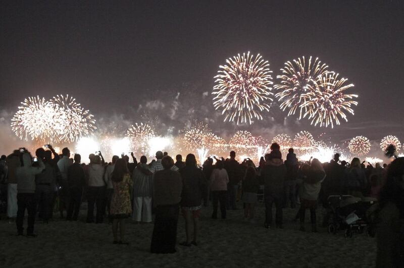 New Year revellers on JBR Beach watch Palm Jumeirah fireworks to ring in 2014 in Dubai. Sarah Dea / The National