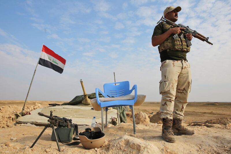 An Iraqi soldier stands guard near the Iraqi city of Qaim at the Iraqi-Syrian border. AFP