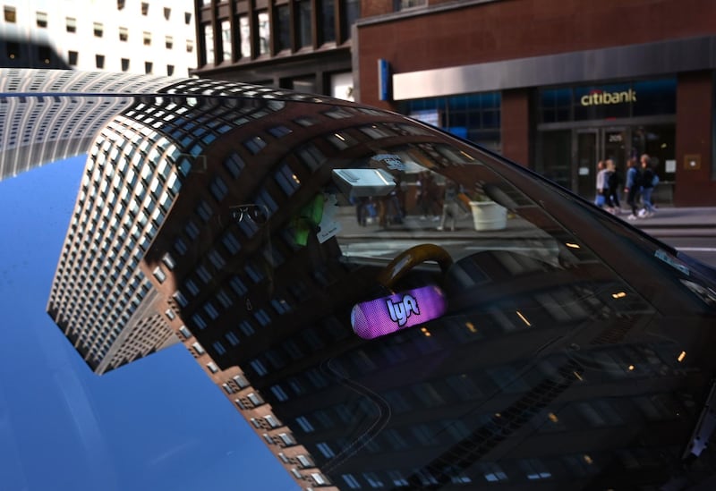 A Lyft ride-sharing car is seen on 42nd Street in New York on March 26, 2019.  Lyft Inc.'s initial public offering is expected to have its (IPO) this week making it the first of the ride-hailing companies to open up to the public. / AFP / TIMOTHY A. CLARY
