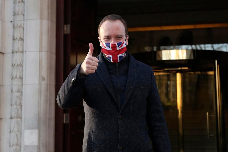 Heath Secretary Matt Hancock gives a thumbs up as he leaves Millbank in Westminster, central London, after the news that a Covid-19 vaccine from Oxford University and AstraZeneca has been approved for use in Britain. AP Photo