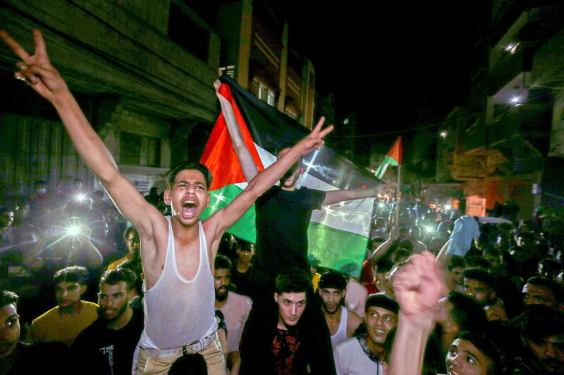 Palestinians celebrate in the streets following a ceasefire in the southern Gaza Strip. Reuters