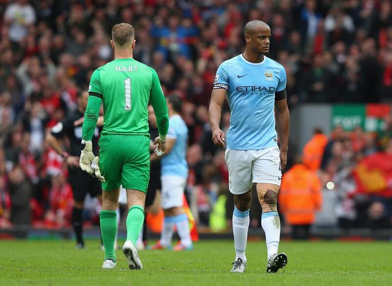 Vincent Kompany, right, of Manchester City looks dejected at the end of the Premier League match between Liverpool and Manchester City at Anfield on April 13, 2014, in Liverpool, England. Alex Livesey / Getty Images