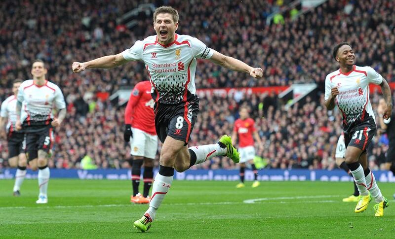 Liverpool's English midfielder Steven Gerrard (celebrates after scoring his team's second goal during the English Premier League football match between Manchester United and Liverpool at Old Trafford in Manchester, Northwest England, on March 16, 2014. Paul Ellis/ AFP