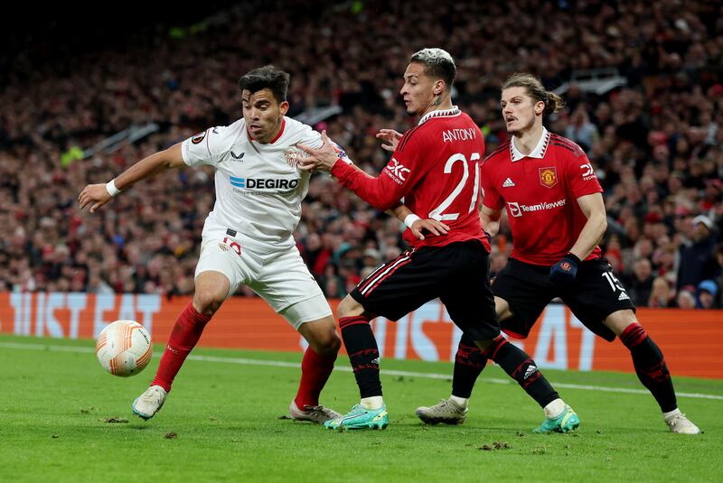 Manchester United's Antony and Marcel Sabitzer in action with Sevilla's Marcos Acuna. Reuters