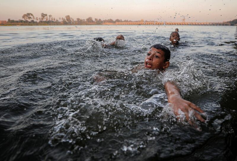 A boy swims in the Nile River during hot weather on the outskirts of Cairo. Reuters