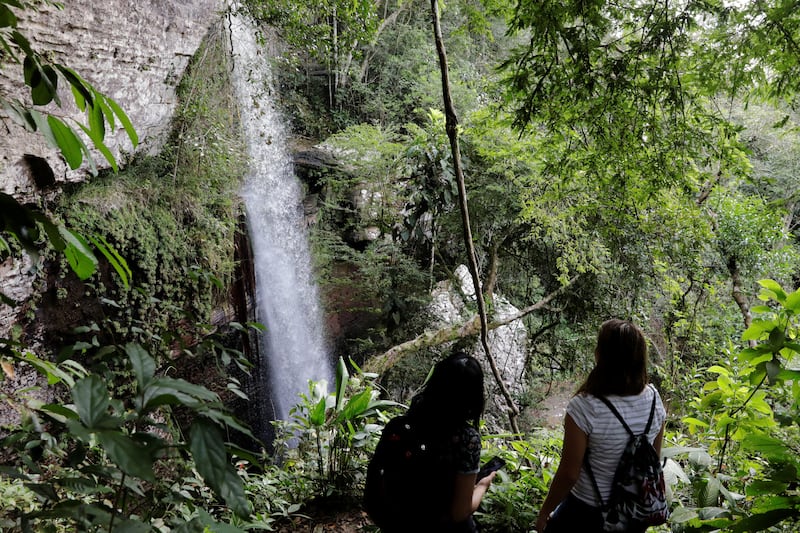 11. Visitors at Las Delicias waterfall in San Jose del Guaviare, Colombia. The country reopened to travellers early in the pandemic.  EPA