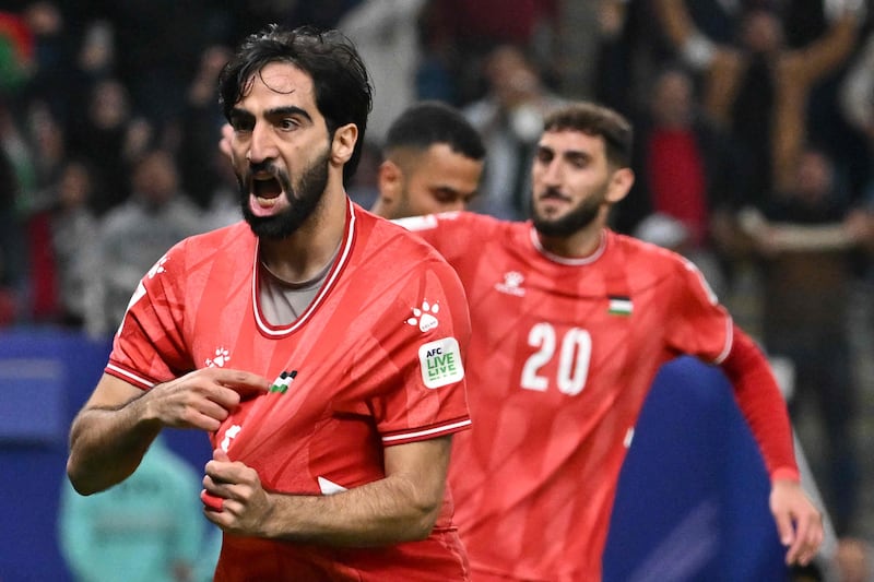 Palestine defender Mohammed Saleh celebrates after UAE's own-goal. AFP