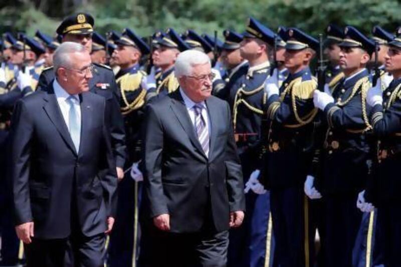 Palestinian president Mahmoud Abbas (right) reviews a guard of honour with Lebanese President Michel Sleiman (L) at the presidential palace of Baabda.
