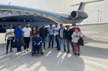 Dr Rahul Gupta (fourth from right) and Dr Rekha Singh (in a wheelchair) are among 13 UAE residents who returned from India recently on a business jet after incoming commercial flights were suspended from India. Courtesy: Dr Gupta