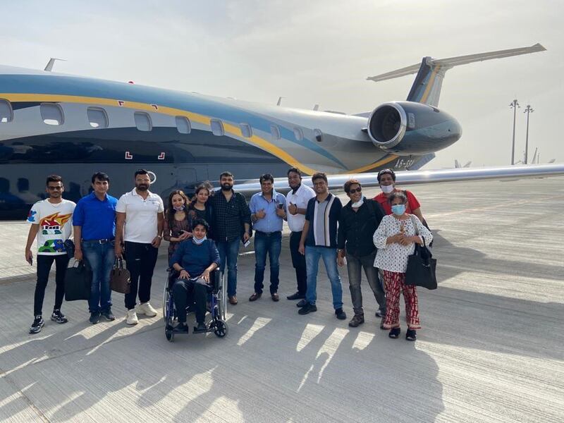 Dr Rahul Gupta (fourth from right) and Dr Rekha Singh (in a wheelchair) are among 13 UAE residents who returned from India recently on a business jet paying $43,000 after incoming commercial flights were suspended from India. Flights from India have been stopped to guard against a deadly Covid-19 strain. Courtesy: Dr Gupta