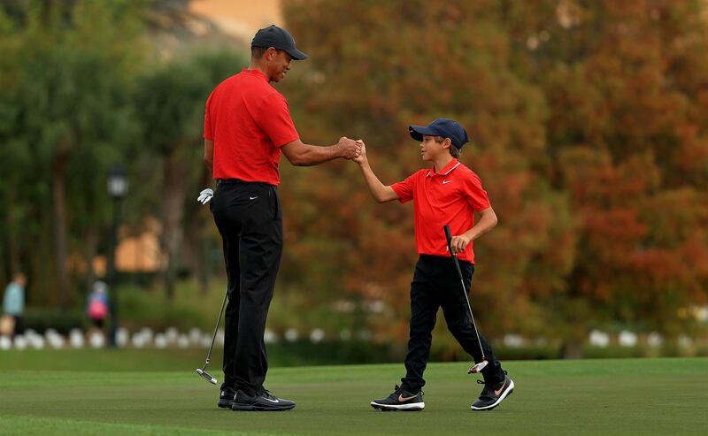 Tiger Woods and son Charlie fist bump on the 18th hole during the final round of the PNC Championship at the Ritz Carlton Golf Club. AFP