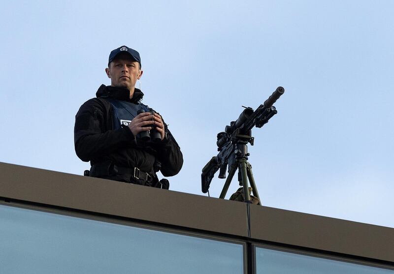 A police sniper stands over the street near the High Court in Christchurch. EPA