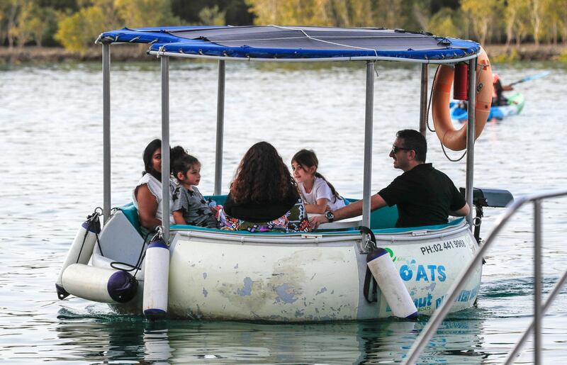 Abu Dhabi, United Arab Emirates, March 12, 2021.  A family enjoys their Friday afternoon on an Eco Donut Boat at the Anantara Eastern Mangroves Marina.
Victor Besa / The National
Section:  NA
FOR:  Stand alone/Big Picture