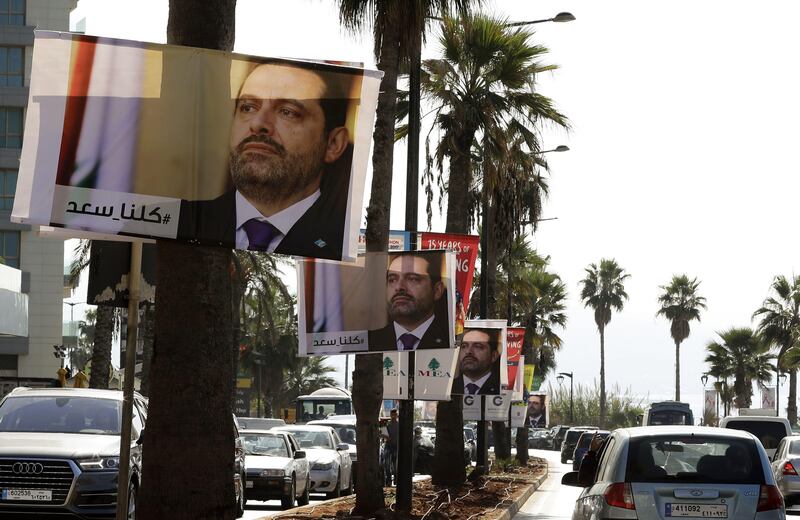 Posters of Lebanese Prime Minister Saad Hariri, who resigned last week in a televised speech airing from the Saudi capital Riyadh, hang on Beirut's seaside corniche on November 10, 2017, with a caption reading below in Arabic: "#We_are_all_Saad".
Hariri's announced resignation sparked concerns of a political crisis in Lebanon as tensions between Saudi Arabia and Iran escalated. / AFP PHOTO / JOSEPH EID