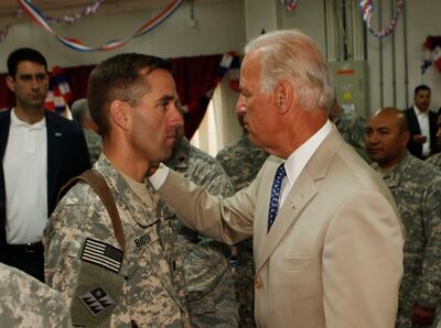 U.S. Vice President Joe Biden (R) talks with his son, U.S. Army Capt. Beau Biden (L) at Camp Victory on the outskirts of Baghdad on July 4, 2009.  Biden said that America's role in Iraq was switching from deep military engagement to one of diplomatic support, ahead of a complete withdrawal from the country in 2011. AFP Photo/ Khalid Mohammed-POOL (Photo by KHALID MOHAMMED / POOL / AFP)