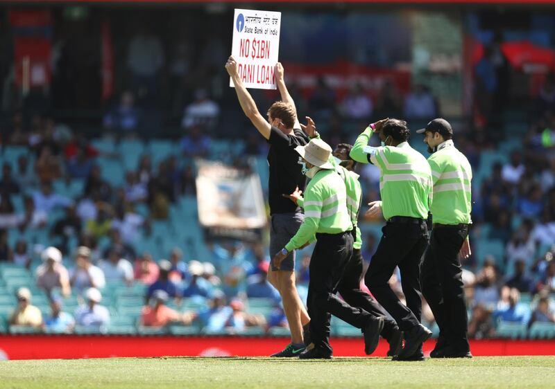 A protester is taken off the Sydney Cricket Ground on Friday. Getty