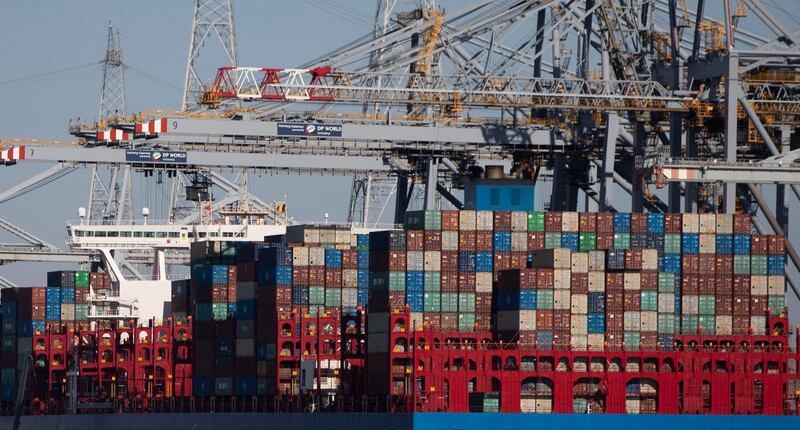 FILE - In this Monday, March 23, 2020 file photo, shipping containers are offloaded in the Port of Antwerp, Belgium. Belgium's federal prosecutor's office says a police operation of an unprecedented scale targeting organized crime is taking place across Belgium on Tuesday, March 9, 2021. With thousands of containers reaching Antwerp every day, the Belgian port city is one of Europe's main ports of entry to Europe for cocaine. Trafficking in the city has led to a surge of violence recently, with gun battles and grenade attacks frequently taking place. (AP Photo/Virginia Mayo, File)