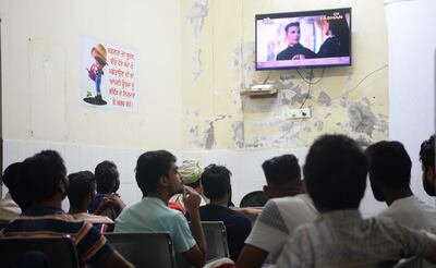 Patients at the rehabilitation centre watch a Hindi film.