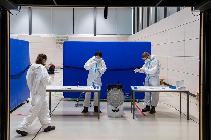 Workers administer rapid antigen tests to high school students at the Ehrenfried Walther von Tschirnhaus Gymnasium high school in Dresden, Germany. Getty Images