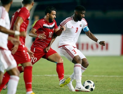 United Arab Emirates' Mohammed Alabdulla,right, battles for the ball with Syria's Mohammad Almarmour, left, during their men's soccer match between United Arab Emirates and Syria at the 18th Asian Games at Si Jalak Harupat Stadium in Bandung, Indonesia, Tuesday, Aug. 14, 2018.(AP Photo/ Achmad Ibrahim)