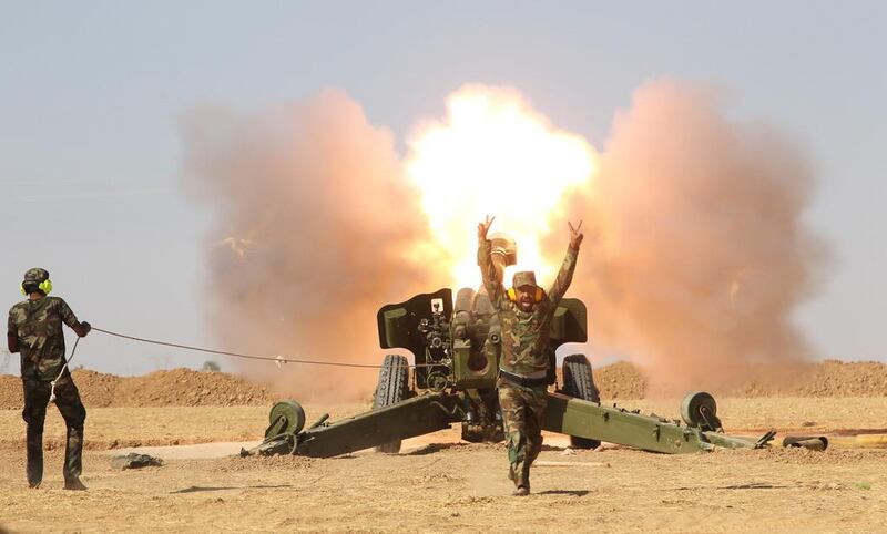 Popular Mobilization Forces personnel fire artillery during clashes with ISIL south of Mosul. Reuters