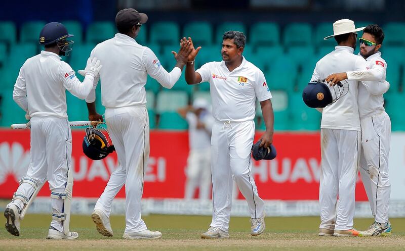 Sri Lanka's Rangana Herath, center, celebrates with teammates after their win over South Africa on the fourth day of their second test cricket match in Colombo, Sri Lanka, Monday, July 23, 2018. Sri Lanka won the series 2-0. (AP Photo/Eranga Jayawardena)
