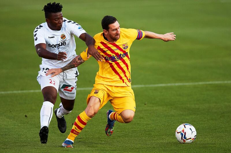 Lionel Messi shields the ball from Thomas Amang during the pre-season friendly between Barcelona and Gimnastic de Tarragona at Johan Cruyff Stadium. EPA