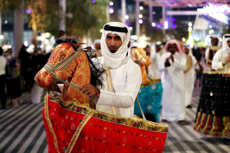 People take part in a parade for Qatar Day at Expo 2020 Dubai