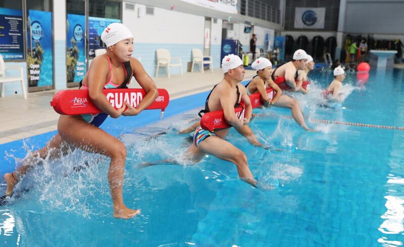 Lifeguards from a branch of the National Red Cross  in Suwon, South Korea, take part in a rescue drill to prepare for the summer season. EPA
