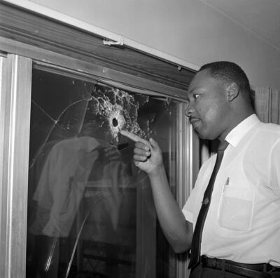 Dr Martin Luther King Jr.  looks at a glass door of his rented beach cottage in St.  Augustine, that was shot into.  The house connected to King is now in the hands of a couple who plans to preserve it. AP