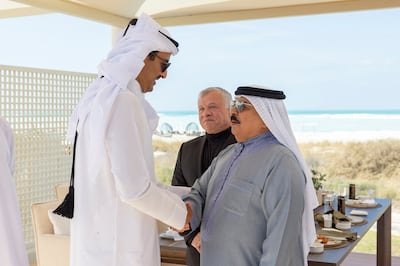 Qatar Emir Sheikh Tamim Al Thani greets Bahrain's King Hamad Al Khalifa, left, with King Abullah II of Jordan looking on. Abu Dhabi, January 18. Photo: UAE Presidential Court
