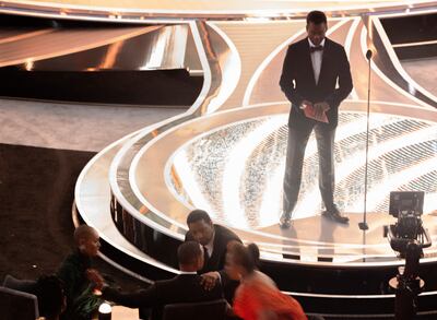 Denzel Washington and Jada Pinkett Smith (L) speak with Will Smith after he hit Chris Rock (top R) on stage, during the 94th Academy Awards in Hollywood on March 27. Reuters