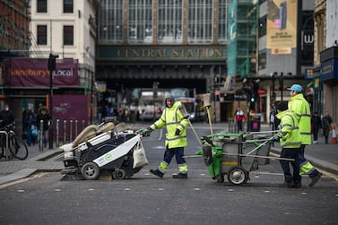 Street cleaners cross Argyll Street in Glasgow, Scotland. Coronavirus has spread to almost 200 countries, claiming more than 10,000 lives. Getty Images