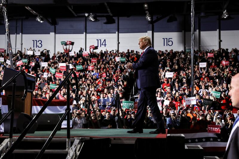 US President Donald Trump walks to the lectern as supporters cheer him on during a campaign rally in Battle Creek, Michigan, December 18, 2019. Reuters