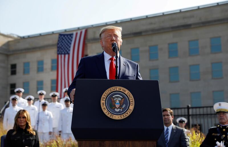 FILE PHOTO: U.S. President Donald Trump speaks next to first lady Melania Trump and Defense Secretary Mark Esper during a ceremony marking the 18th anniversary of September 11 attacks at the Pentagon in Arlington, Virginia, U.S., September 11, 2019. REUTERS/Kevin Lamarque/File Photo