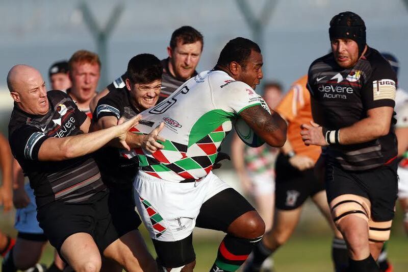 Jean Boates, right, and his Abu Dhabi Saracens teammates attempt to tackle Willie Umu of Abu Dhabi Harlequins. Photo Courtesy / West Asia Championship